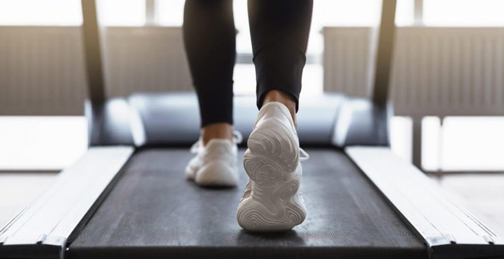 Legs of a person walking a treadmill