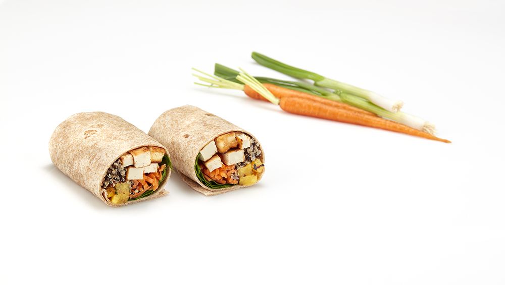 Vegetarian wrap filled with teriyaki tofu, pineapple, quinoa and spinach
